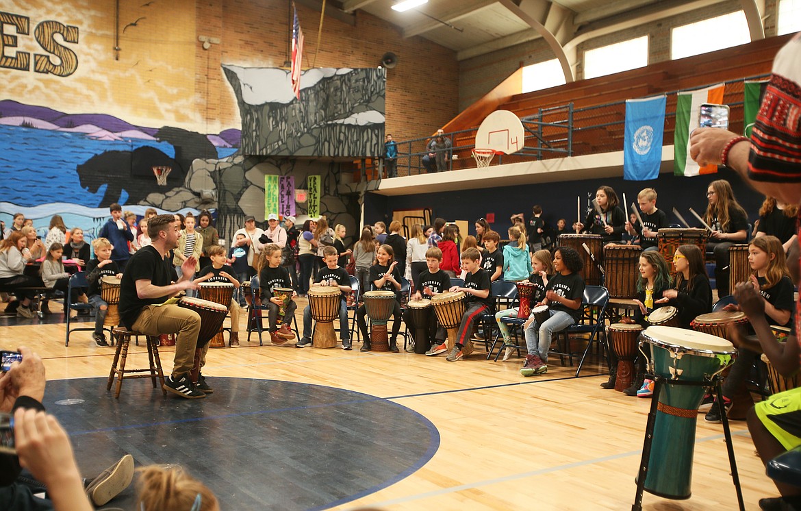Percussion bounces off the walls and into the halls of Lakes Magnet Middle School on Saturday as James Schmehl leads the Sorensen Magnet School Drumming Team in a performance for the Community Multicultural Faire. (DEVIN WEEKS/Press)