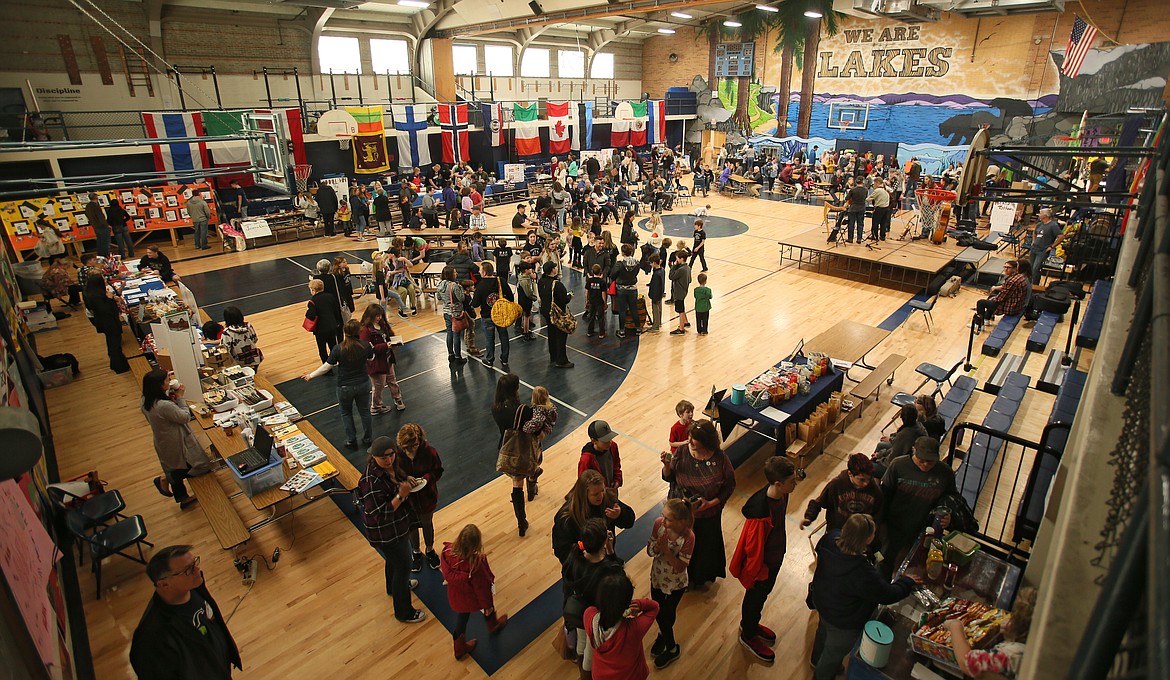 Community members browse booths and try different ethnic foods as they enjoy the 10th annual Lakes Middle School Community Multicultural Faire in the gym on Saturday. Countries represented included France, Italy, Norway and Mexico. Information about diversity and inclusion was also available at different booths. (DEVIN WEEKS/Press)