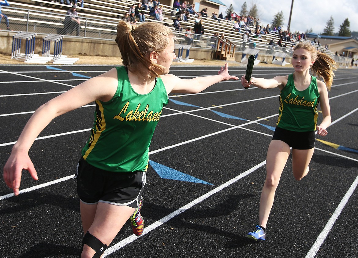 Lakeland&#146;s Devon Joussaint, right, transfers the baton to Dorthy Gallus in the 4 x 800 meter relay at the Kootenai County Challenge on Friday in Spirit Lake. (LOREN BENOIT/Press)