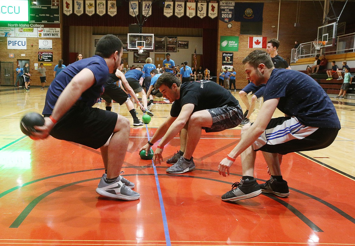 Participants rush to the line to grab dodgeballs during the inaugural community dodgeball tournament held in the Christianson Gym on Friday. (LOREN BENOIT/Press)