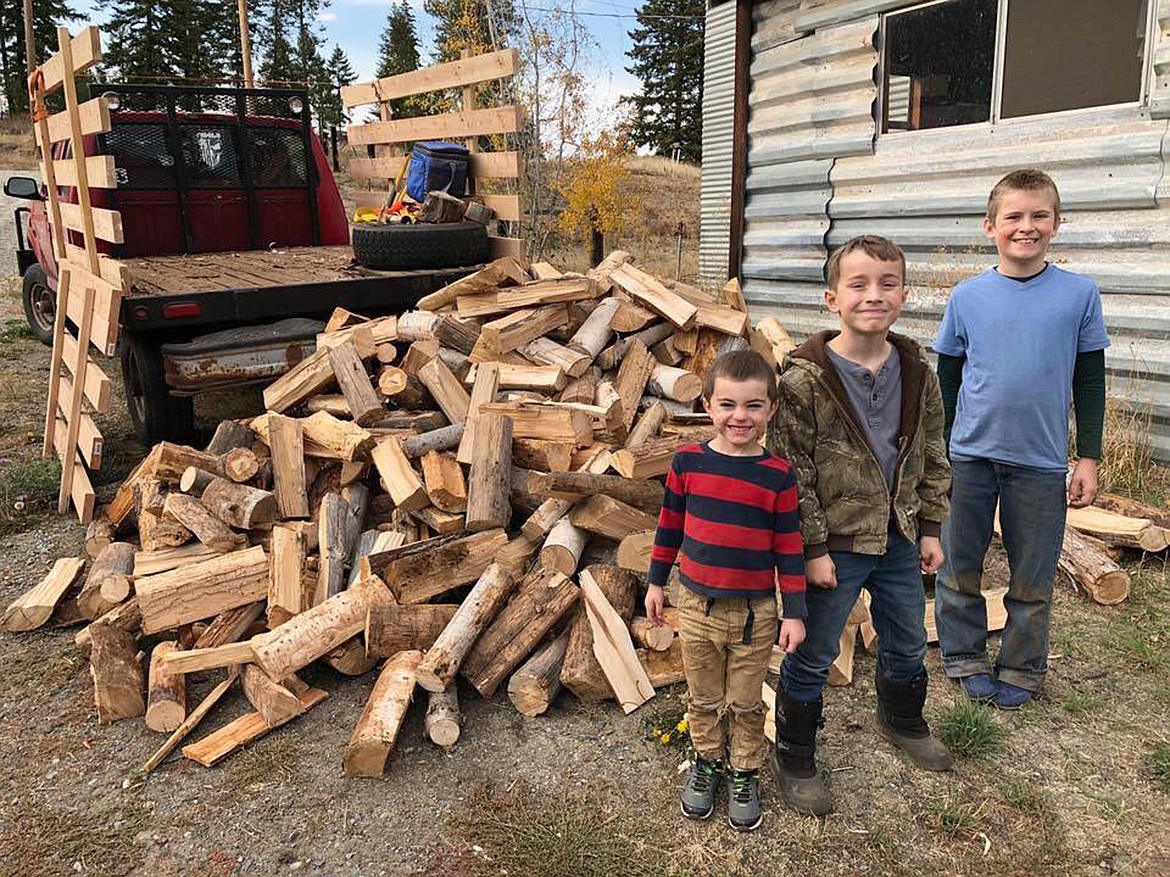 (Courtesy photo)Sarah Hines' three son, Sam, Brittian, and D4, help unload firewood.