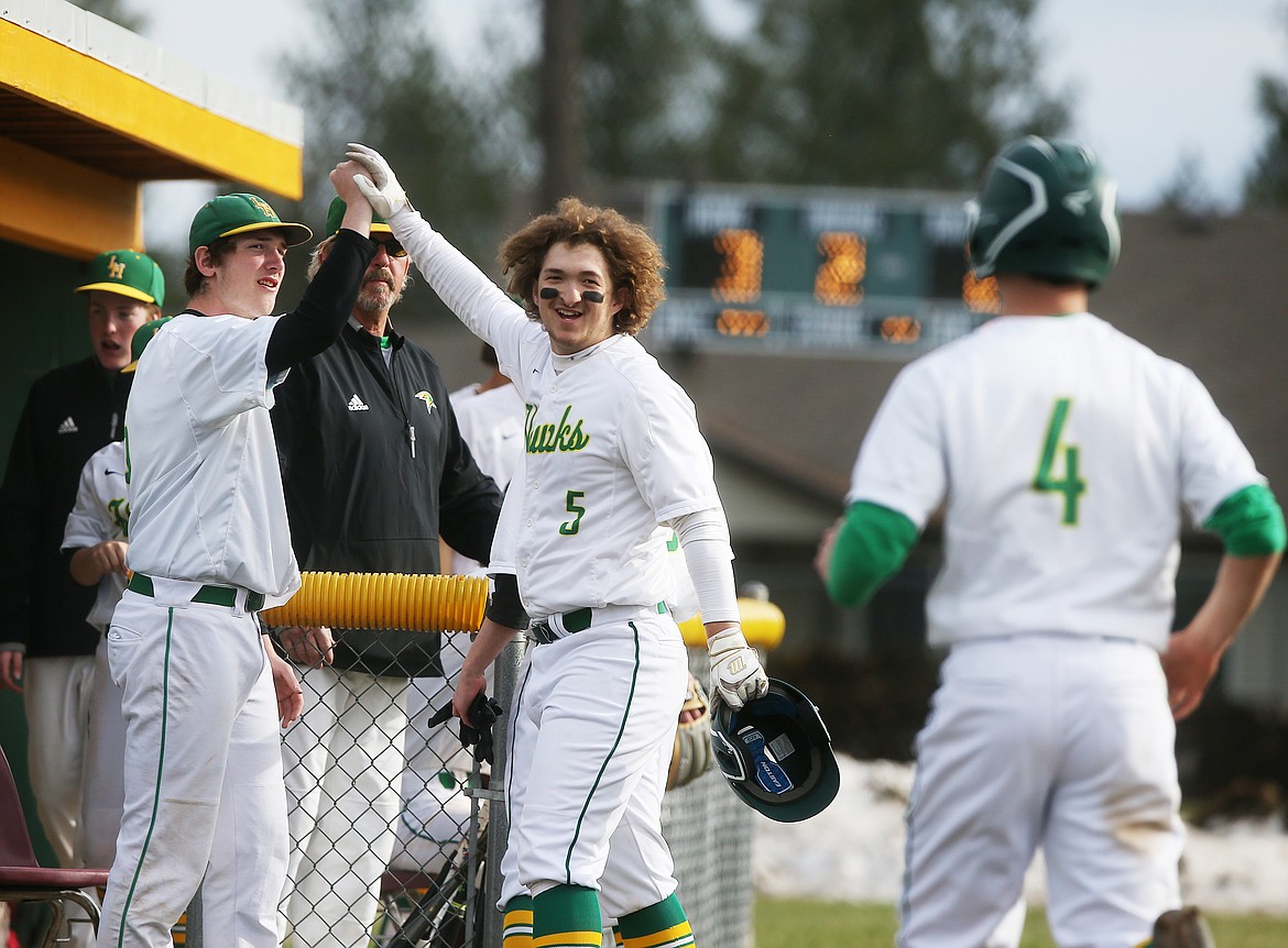 Lakeland&#146;s Colton Aragon, center, celebrates a sacrifice fly, which scored Collin Bell, right, during Thursday&#146;s game against Timberlake High. (LOREN BENOIT/Press)