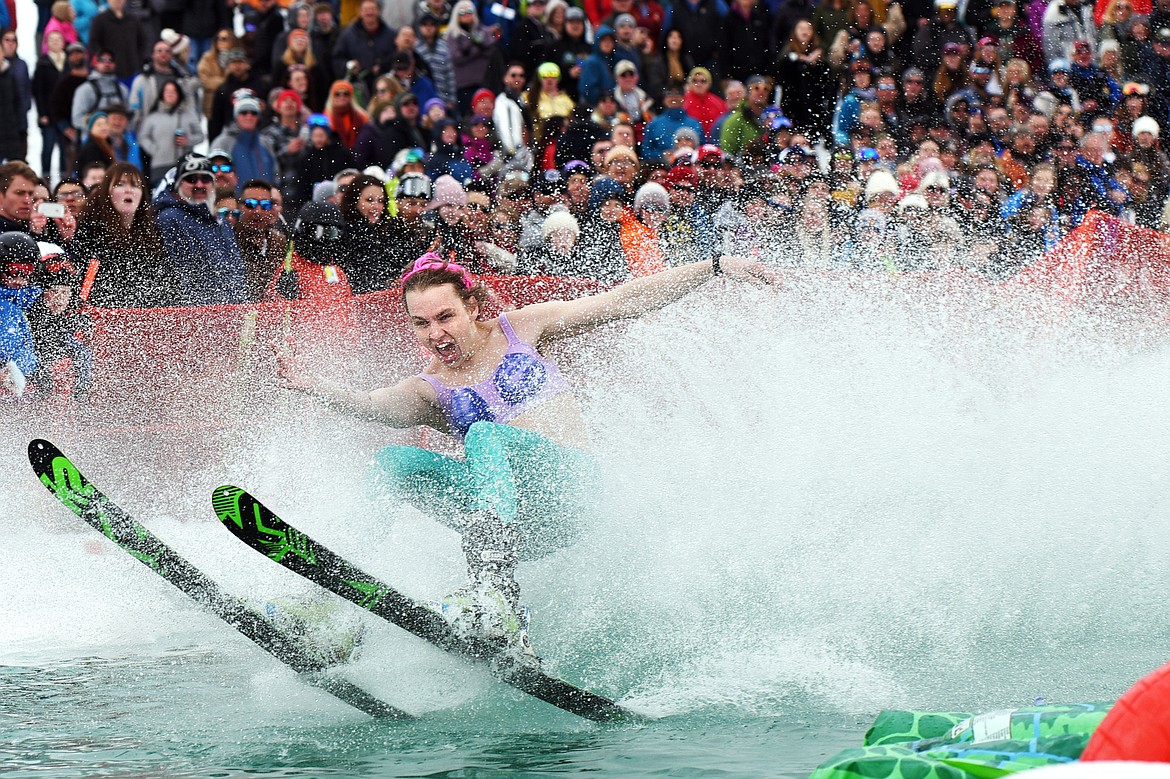 Corbin Richards, dressed as a mermaid, blasts across the pond during the 2019 Whitefish Pond Skim at Whitefish Mountain Resort on Saturday. (Casey Kreider/Daily Inter Lake)