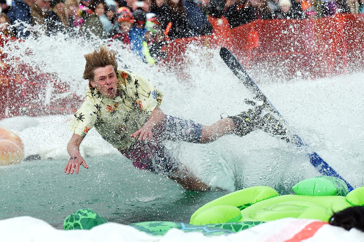 Ryan Economy falls skimming across the pond during the 2019 Whitefish Pond Skim at Whitefish Mountain Resort on Saturday. (Casey Kreider/Daily Inter Lake)