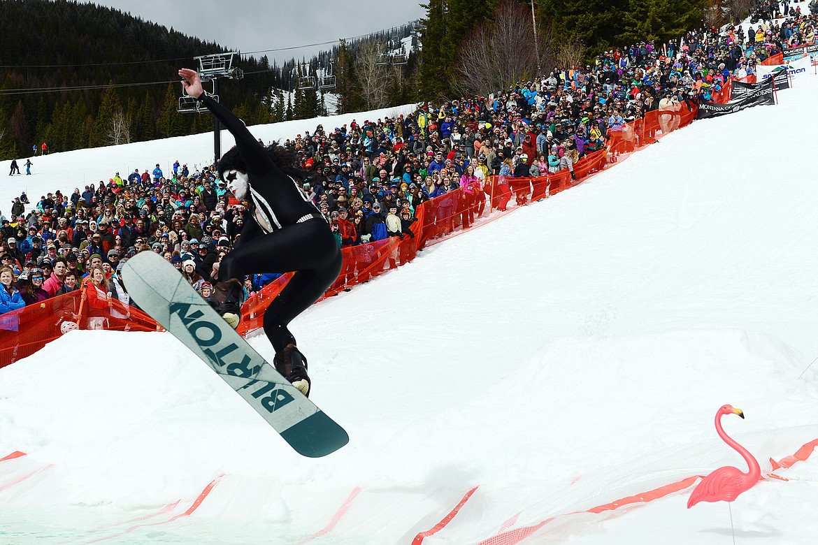 Cody Wesche, dressed as Paul Stanley from the band KISS, hits a ramp during the 2019 Whitefish Pond Skim at Whitefish Mountain Resort on Saturday. (Casey Kreider/Daily Inter Lake)