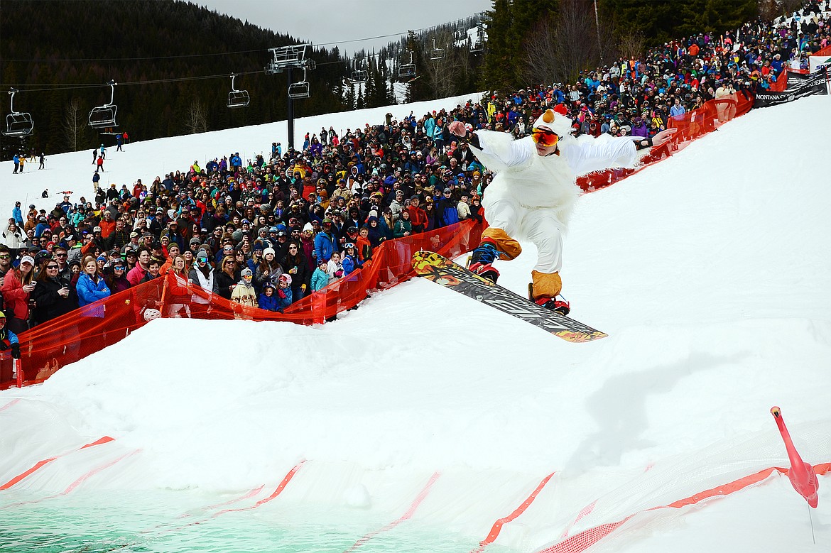 Stone Bender, dressed as a chicken, hits a ramp during the 2019 Whitefish Pond Skim at Whitefish Mountain Resort on Saturday. (Casey Kreider/Daily Inter Lake)