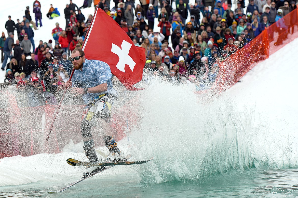 A member of the Whitefish Mountain Resort Ski Patrol flies across the pond during the 2019 Whitefish Pond Skim at Whitefish Mountain Resort on Saturday. (Casey Kreider/Daily Inter Lake)