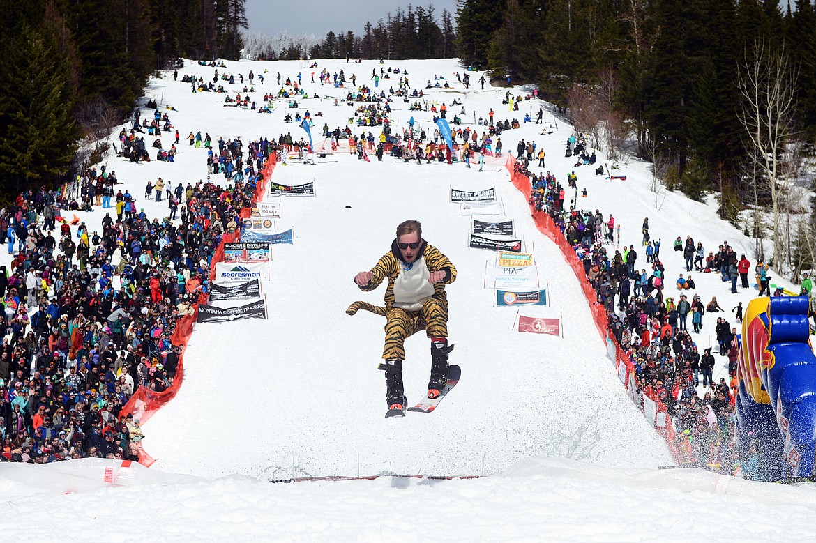 Johnny Highfill flies out of the pond during the 2019 Whitefish Pond Skim at Whitefish Mountain Resort on Saturday. (Casey Kreider/Daily Inter Lake)