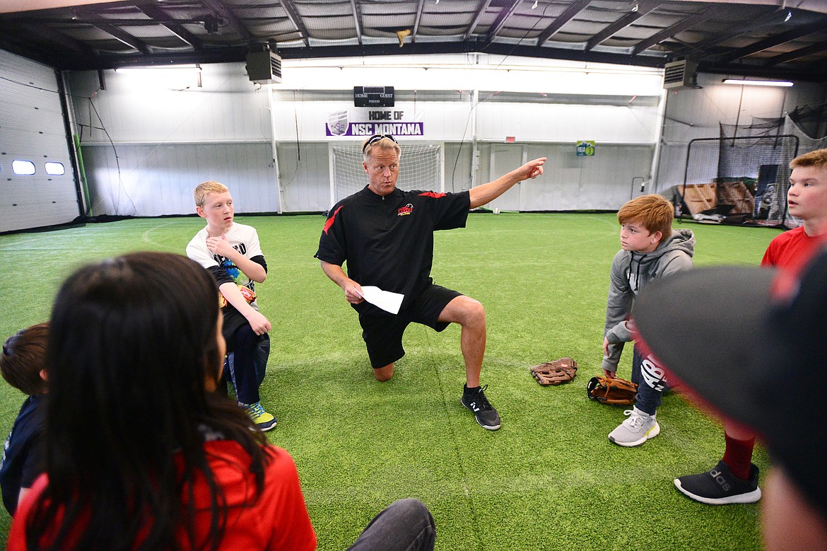 Jeff Berke, a coach with the Kalispell Lakers 12U team, talks to his squad before a workout at The Fort, an indoor multi-sport turf facility in Kalispell, on Thursday, April 4. (Casey Kreider/Daily Inter Lake)