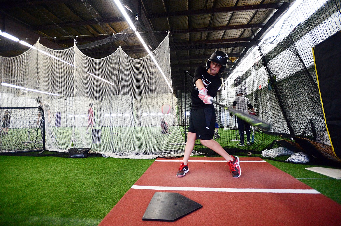 Tristan Berke, 12, with the Kalispell Lakers 12U team, hits soft-toss inside the batting cage at The Fort, an indoor multi-sport turf facility in Kalispell, on Thursday, April 4. (Casey Kreider/Daily Inter Lake)