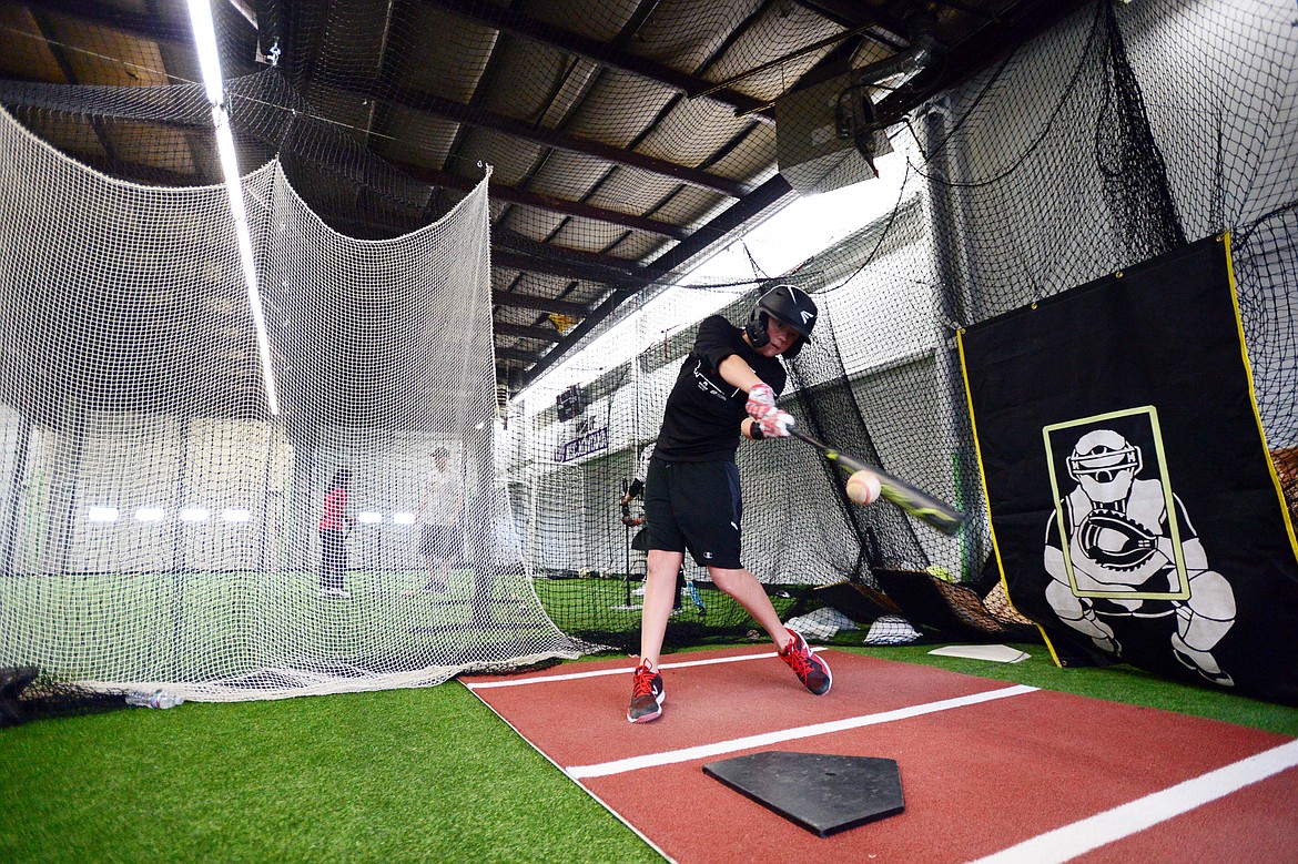 Tristan Berke, 12, with the Kalispell Lakers 12U team, hits soft-toss inside the batting cage at The Fort, an indoor multi-sport turf facility in Kalispell, on Thursday, April 4. (Casey Kreider/Daily Inter Lake)