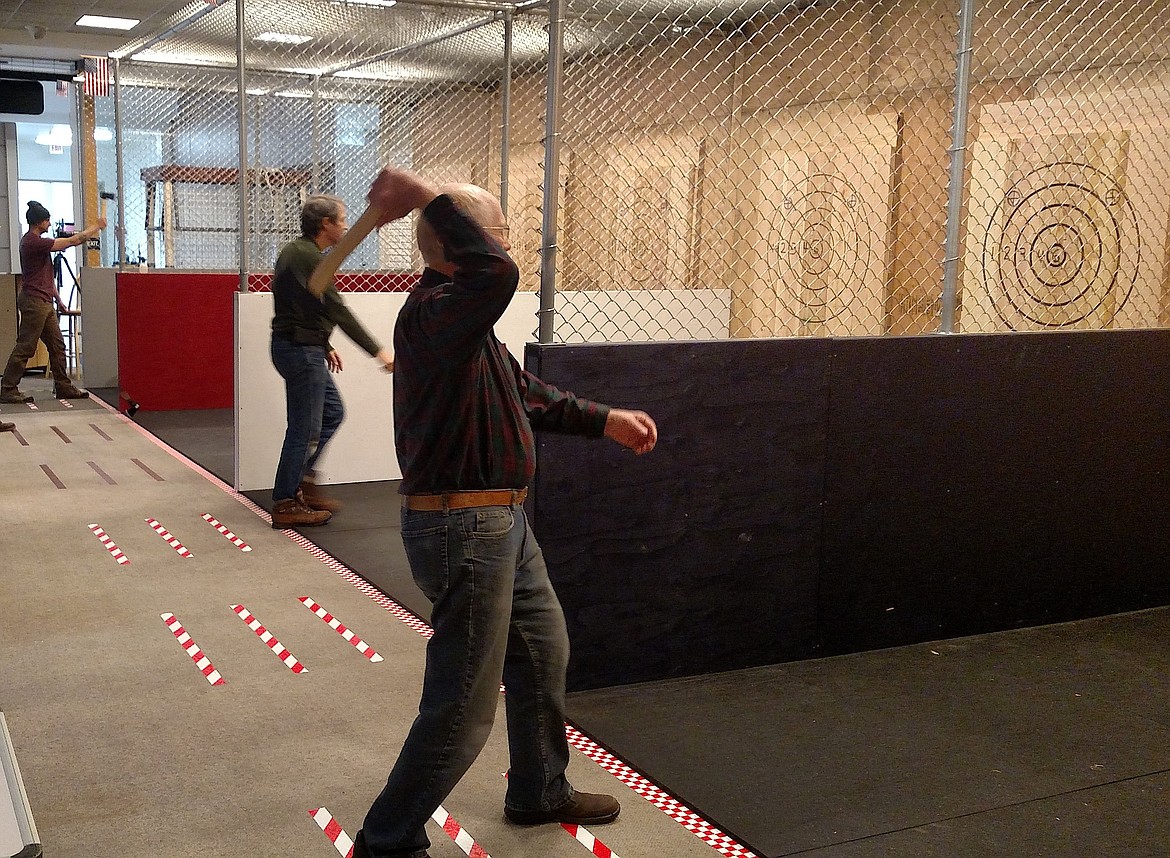 Participants try their hand at ax throwing at the new Axe Force One business in the Silver Lake Mall in Coeur d'Alene. (Courtesy photo)
