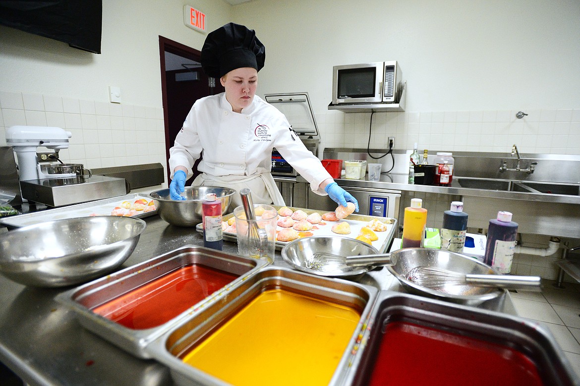 Haley Lindgren works on pesches, an Italian peach cookie, inside the kitchen at the Culinary Institute of Montana at Flathead Valley Community College on Wednesday, April 3. (Casey Kreider/Daily Inter Lake)