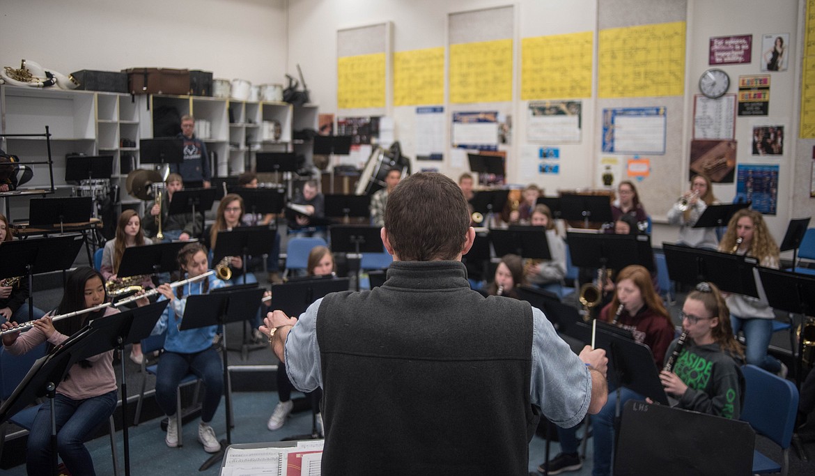 Matthew Krantz, band director for Libby Public Schools, helps guide high school students as they learn to play music from The Greatest Showman, Wednesday in Libby. (Luke Hollister/The Western News)