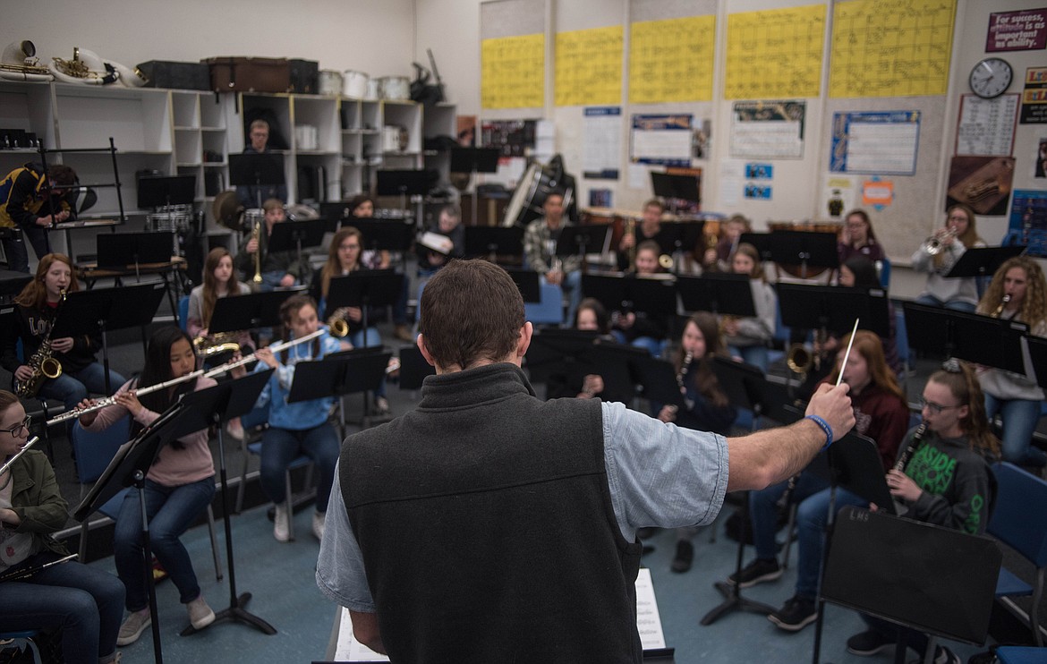 Matthew Krantz, band director for the school district, helps guide high school students as they learn to play music from The Greatest Showman, Wednesday in Libby.