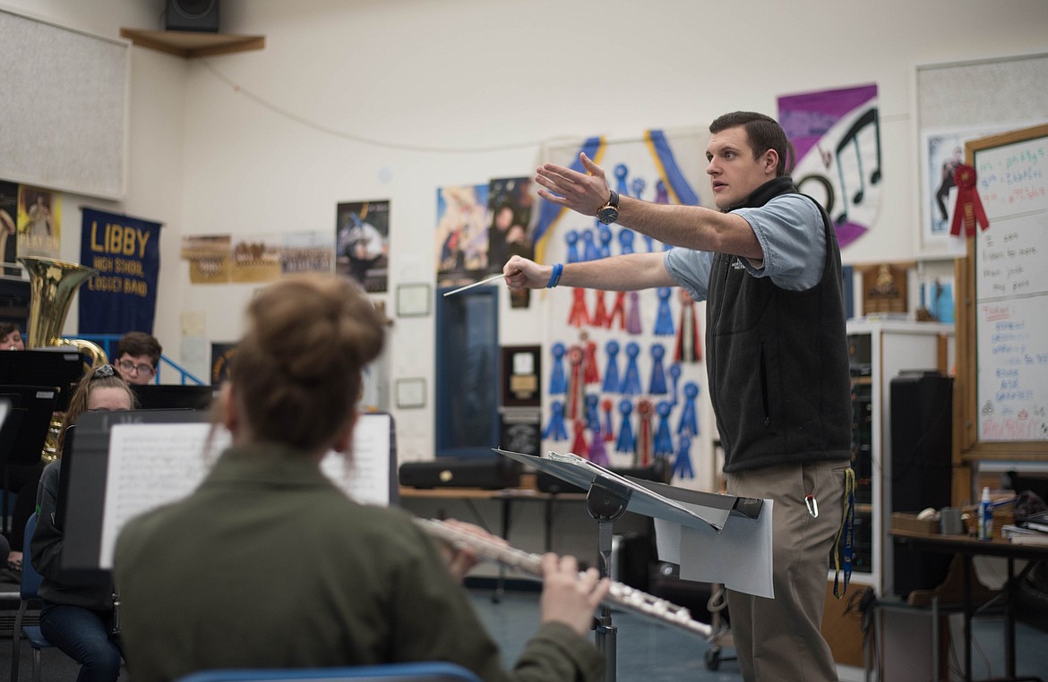 Matthew Krantz, band director for the school district, helps high school flute students play their part in music from The Greatest Showman, Wednesday in Libby.