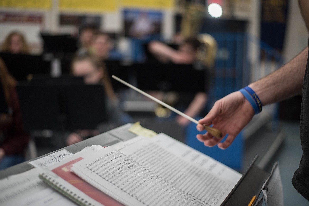 Matthew Krantz counts down, tapping his baton to prepare band students to play, Wednesday at Libby High School. (Luke Hollister/The Western News)