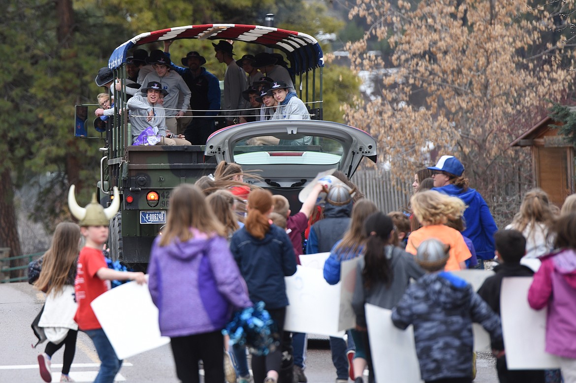 Bigfork students chase after a vehicle carrying the Bigfork boys basketball team during a Wednesday parade in Bigfork celebrating the Vikings&#146; Class B state championship. Bigfork beat Missoula Loyola 47-43 on March 8 in Belgrade to finish the season with a 22-2 record. Bigfork also won the state championship in 2018 with a 24-0 mark. (Casey Kreider/Daily Inter Lake)