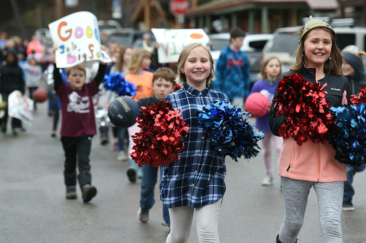 Bigfork students wave signs and 
pompoms as they follow a vehicle carrying the Bigfork boys basketball team during a Wednesday parade in Bigfork 
celebrating the Vikings&#146; Class B state 
championship. (Casey Kreider/Daily Inter Lake)