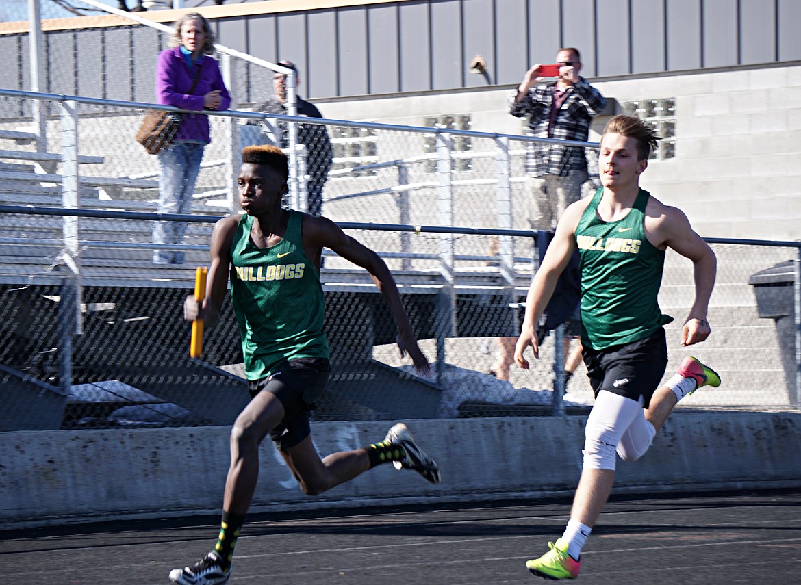 Bulldog Marvin Kimera takes off after getting the batton from Jack Schwaiger in the 4X100 relay last week at Legends Field. (Photo courtesy Matt Weller)
