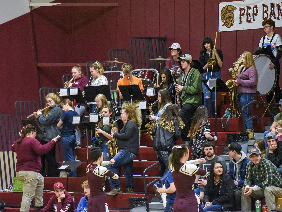 Sheri Hand leads the Troy High School pep band during a home basketball game in February. (Ben Kibbey/The Western News)