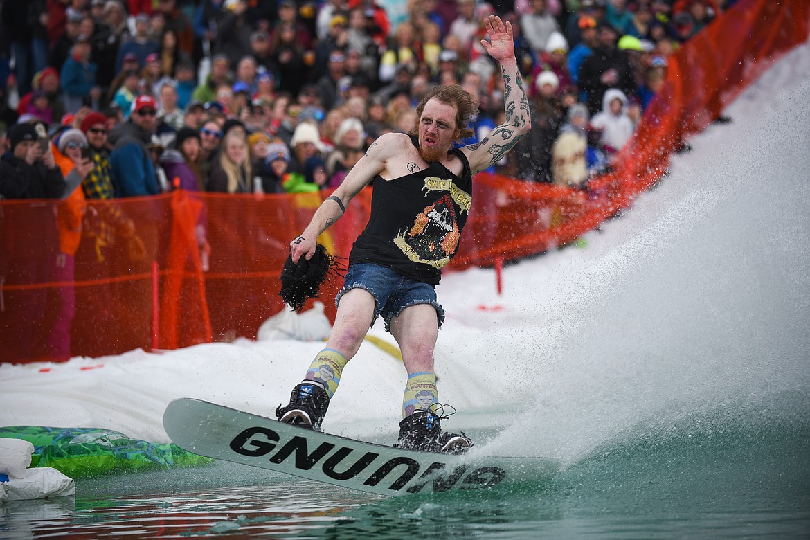 Chase Matteson, dressed as &#147;Skid,&#148; easily floats across the water during the 2019 Pond Skim on Saturday at Whitefish Mountain Resort. (Daniel McKay/Whitefish Pilot)