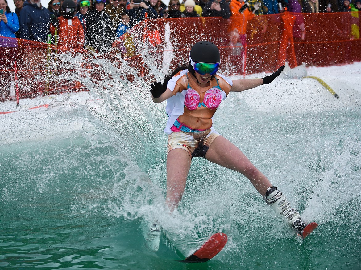 Ashley Best, dressed as &#147;Koocanusa,&#148; starts to fall during the 2019 Pond Skim on Saturday at Whitefish Mountain Resort. (Daniel McKay/Whitefish Pilot)