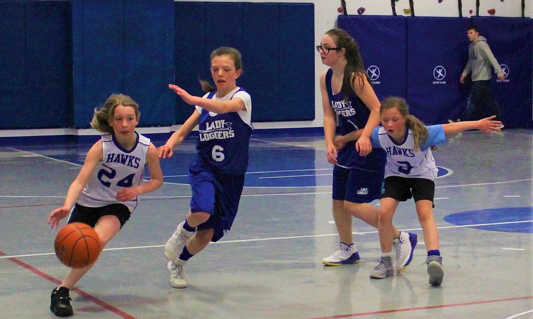 THOMPSON FALLS&#146; Aubrey Baxter dribbles past a Libby player as #3 Addi Pardee blocks another in the fifth- and sixth-grade division during the Superior Hoop Shoot held on March 30 and 31 in Superior. (Kathleen Woodford photos/Mineral Independent)
