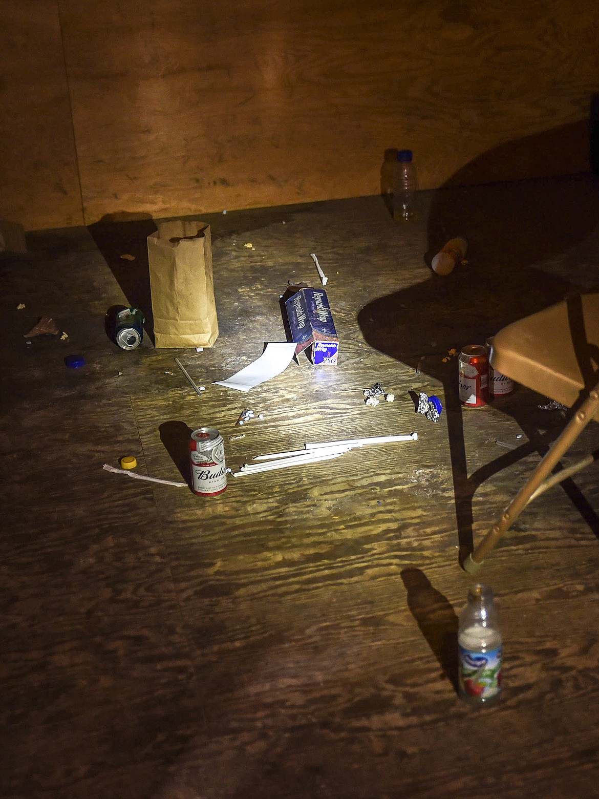 Libby Assistant Chief/Fire Marshall Steve Lauer shines a light on beer cans and other trash left in the upstairs training area used by the Libby Volunteer Fire Department above the concession stand Monday. (Ben Kibbey/The Western News)