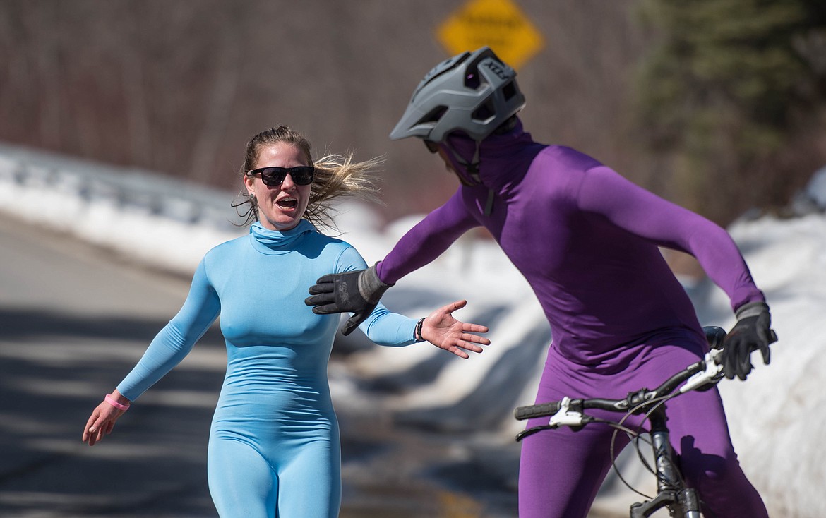 Carrie Galloway, left, runs to tag Cass Hopkinson during the annual Top to Dog Race, Saturday on Pipe Creek Road. Their team, the Sour Patch Kidz, won with a combined time of 1 hour, 27 minutes and 32 seconds Saturday. (Luke Hollister/The Western News)