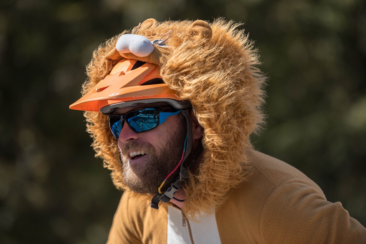 Ian Graham, dressed in a yellow onesie, starts the last stretch of the Top to Dog Race, Saturday on Pipe Creek Road. (Luke Hollister/The Western News)