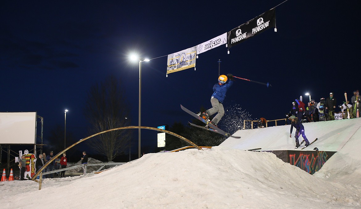 DEVIN WEEKS/Press
Snow sprays behind 12-year-old Seth Dye&#146;s skis Saturday night as he lands a jump during the 10th annual Jam for Cans Charity Rail Jam in Post Falls.