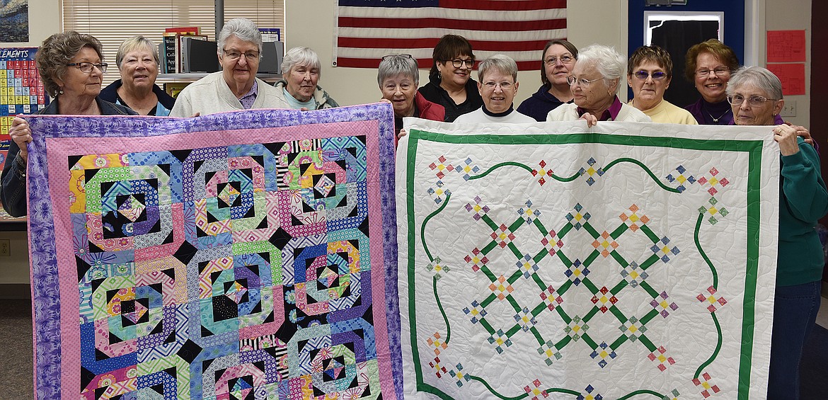 GUILD MEMBERS gathered for their March meeting to get everything set for the April 13 Annual Quilt Show. Pictured, from left, are Jo Carder (treasurer), Donna Abrams, Doris Stowe, Judy Faro, Ann Lundmark, Jennifer McCrea (president), Carlene Bachmann, Lorraine Renard, Dorothy Rawie, Valerie Hoynacki (2019 Featured Quilter), Ella Larson (vice president) and Brenda Shively (secretary). Not pictured: Claudia Paul, Joyce Reeser, Diane Lorango, Melissa Compton, Sally Havens and Jan Pitts. Quilts by Doris Stowe and Dorothy Rawie. (Carolyn Hidy/Clark Fork Valley Press)