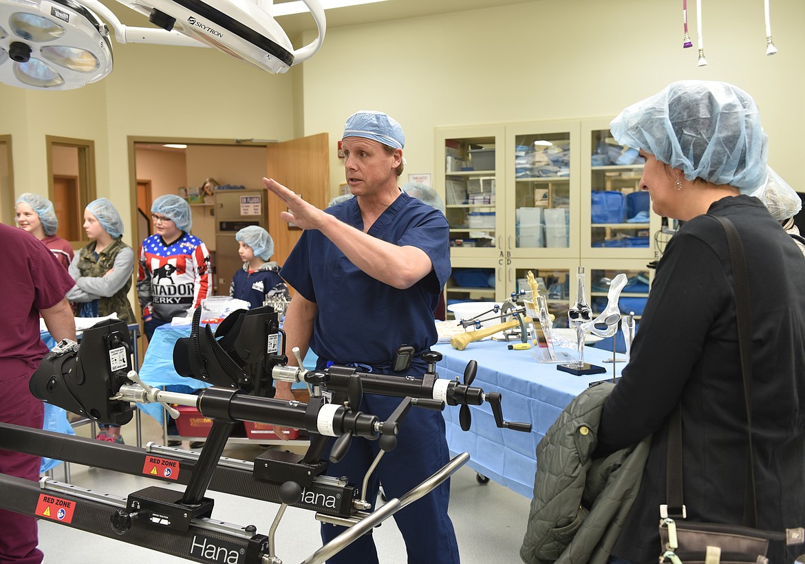 DR. ROBERT Blease, Clark Fork Valley Hospital orthopedic surgeon, shows off the new hip-replacement table that works in coordination with X-ray video during an open house March 21. &#147;This set-up cost as much as a small airplane. It takes a lot of the guesswork out of it,&#148; he quips. (Carolyn Hidy photos/Clark Fork Valley Press)