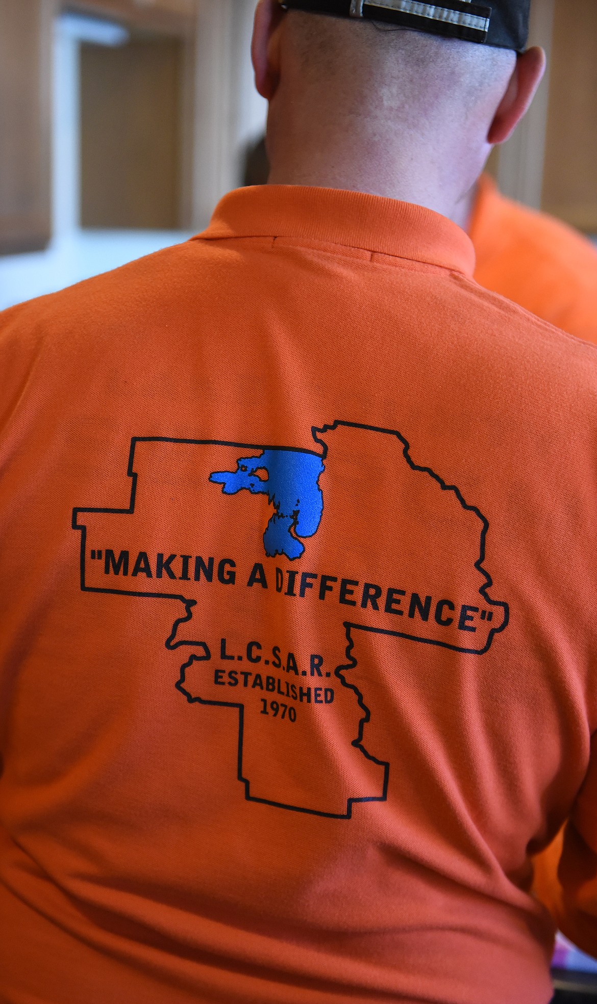 THERE WAS orange everywhere during the First Responders Appreciation Lunch last Saturday in Polson. Many of the 40 first responders on the Lake County roster, led by Jared and Jamie Bell, helped by cooking and serving food to everyone who attended. At the T-shirt at left says, &#147;Making a Difference&#148; is what LC Search and Rescue is all about.
(Joe Sova photos/Lake County Leader)