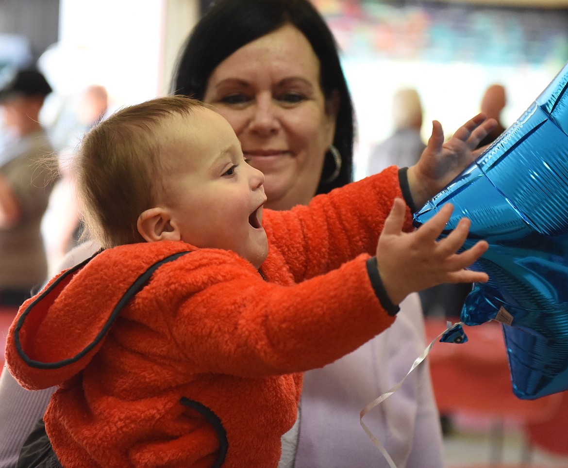 ONE-YEAR-OLD PAXTON Bell, above, was elated when he got to touch one of the balloons flying during the First Responders Appreciation Lunch on Saturday, March 30 in Polson. Paxton is held by his grandmother Valerie Bell, the wife of Sheriff Don Bell. At right are some of the posters made by local students in support of all types of law enforcement and emergency personnel.