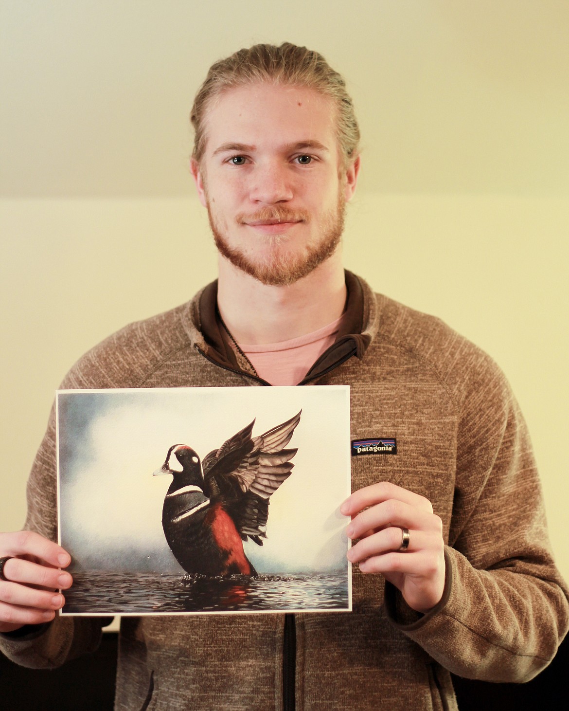 PLAINS HIGH School senior Malachi Paulsen shows his pencil drawing that won Best of Show in the Montana Junior Duck Stamp competition held March 21 at the Lee Metcalf National Wildlife Refuge at Stevensville. Paulsen&#146;s depiction of a harlequin duck is in the running for a national honor. (Courtesy photo)