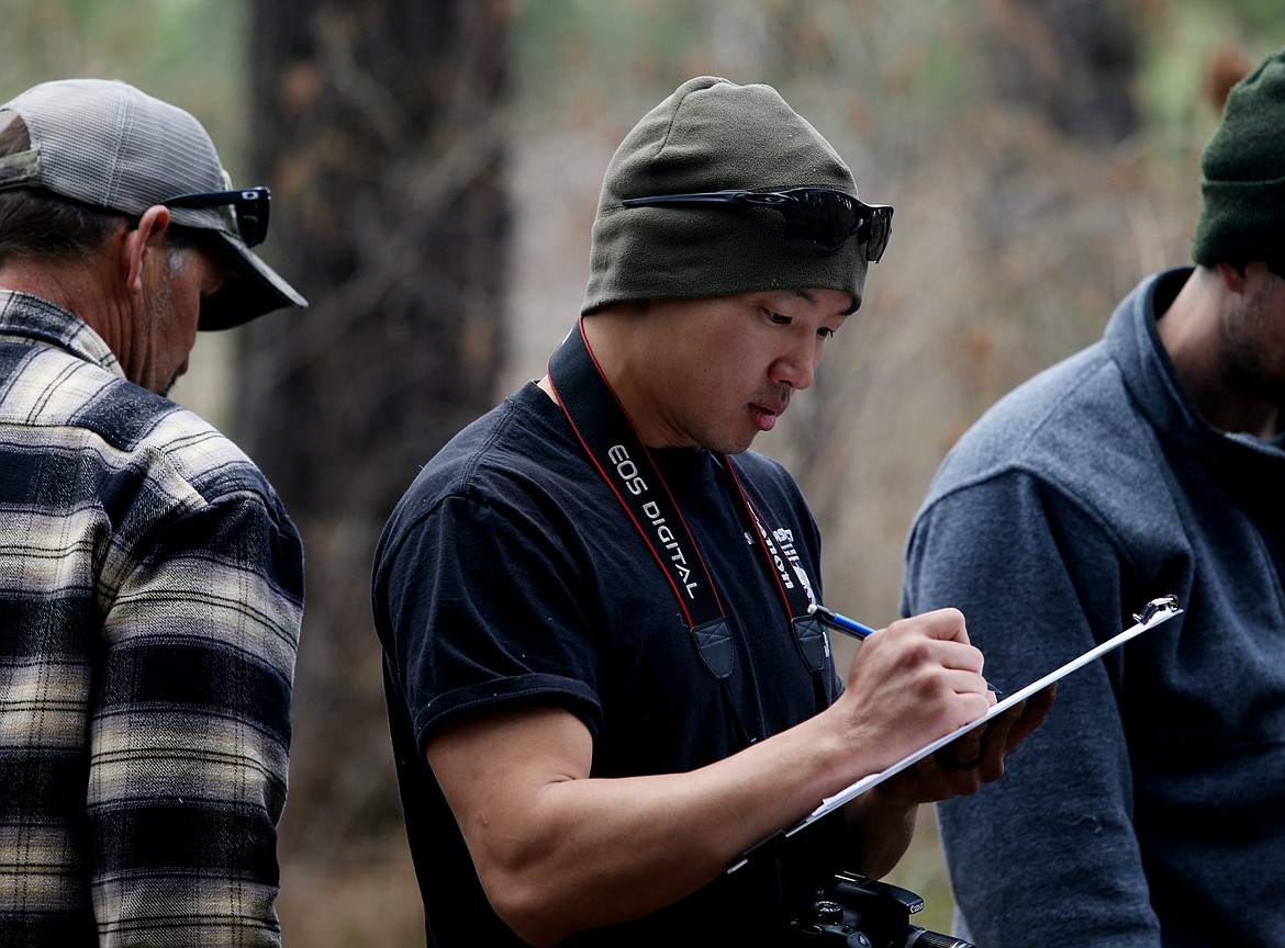 Ben Chu with Bureau of Land Management writes down notes on a mock fire's direction of travel during a fire investigation training event near Stateline on Thursday. (LOREN BENOIT/Press)