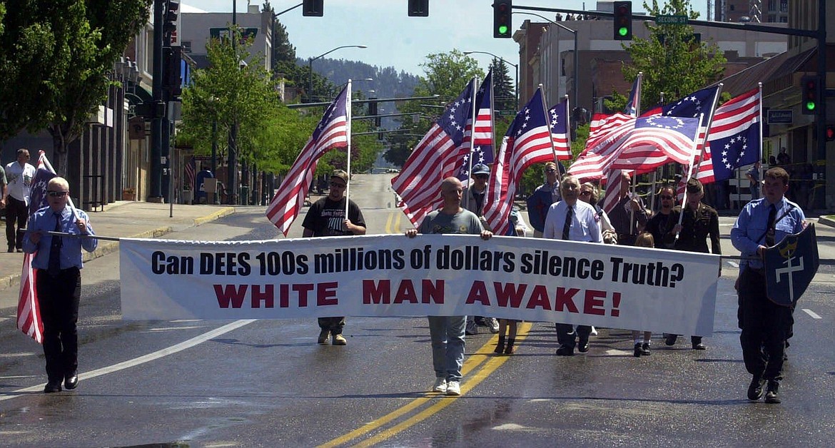 Aryan Nation members march during their annual parade in Coeur d'Alene, Idaho, Saturday, July 7, 2001. Reflecting how far the Aryan Nations has fallen since losing a $6.3 million civil rights lawsuit, only a small number of people marched in the parade. (JASON HUNT/Press file)