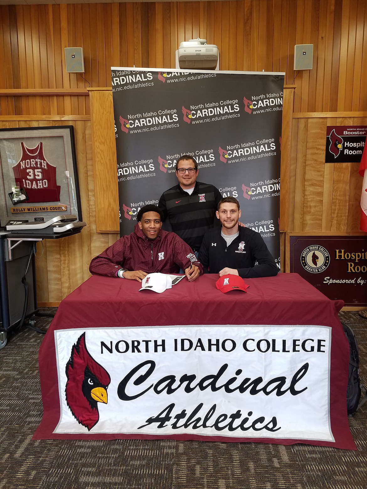Courtesy photo
North Idaho College sophomore Hasaan Hawthorne recently signed a letter of intent to wrestle at NAIA Hastings College in Hastings, Neb. Seated from left are Hasaan Hawthorne and Brandon Richardson, NIC interim wrestling coach; and standing is Tyson Springer, Hastings College head wrestling coach.