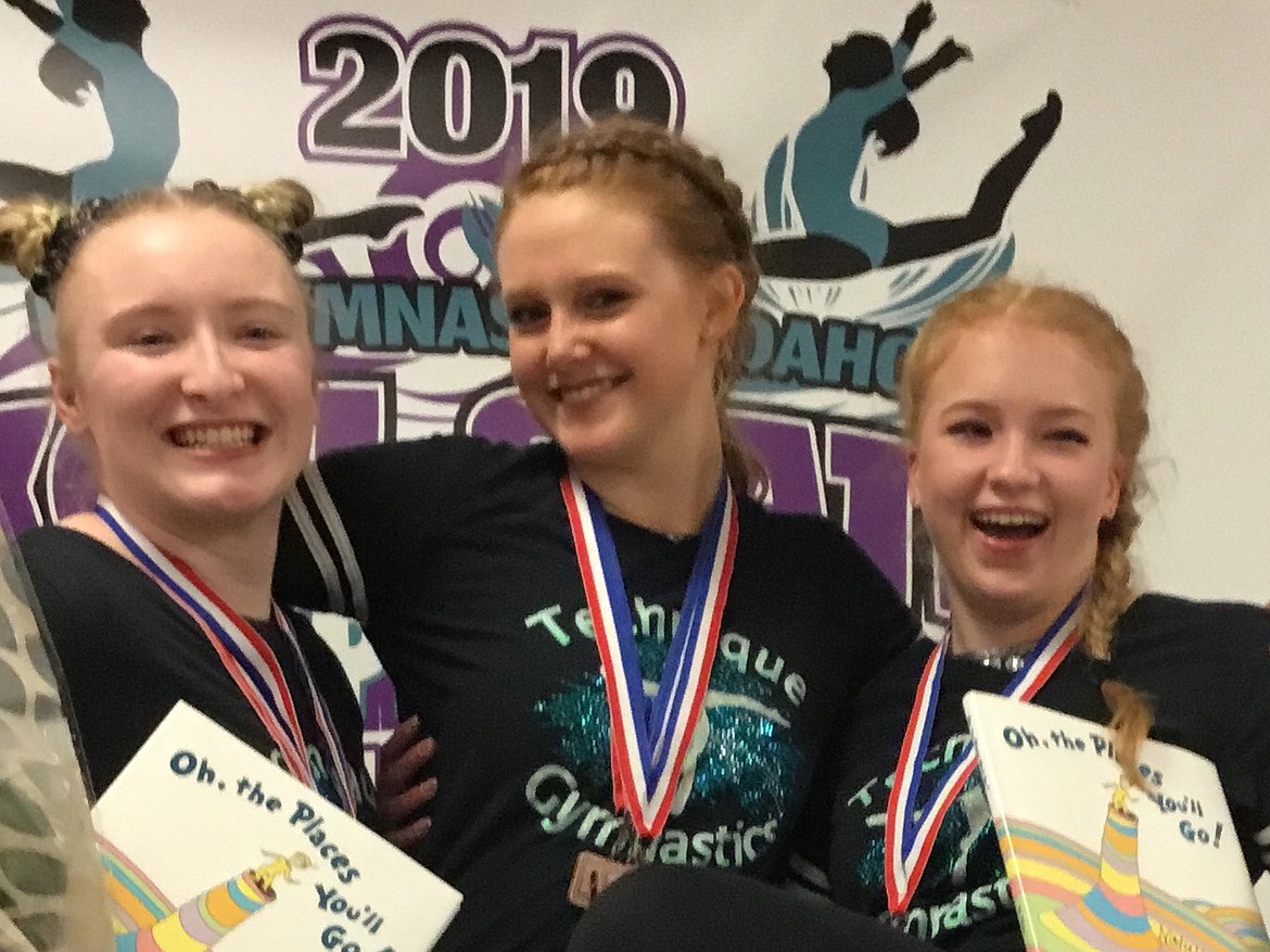 Courtesy photo
Technique Gymnastics seniors Bethany Frey, Amber Shoolroy, and Natalie Brett celebrating their final Xcel State Championship at the recent state meet in Hailey.