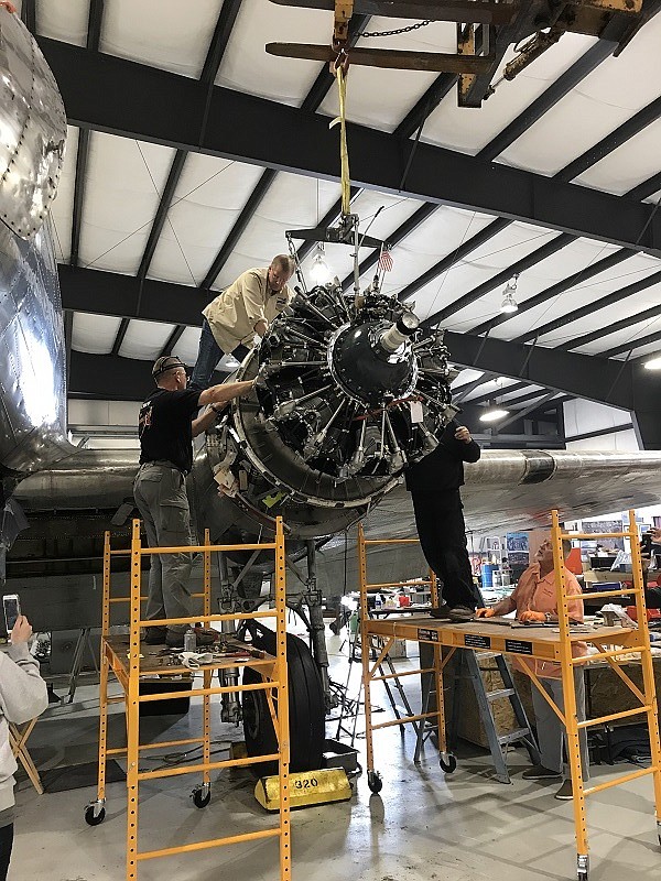 Installing newly overhauled engines at Museum of Mountain Flying hangar in Missoula, Mont. (Photo courtesy of NOLAN WILEY)
