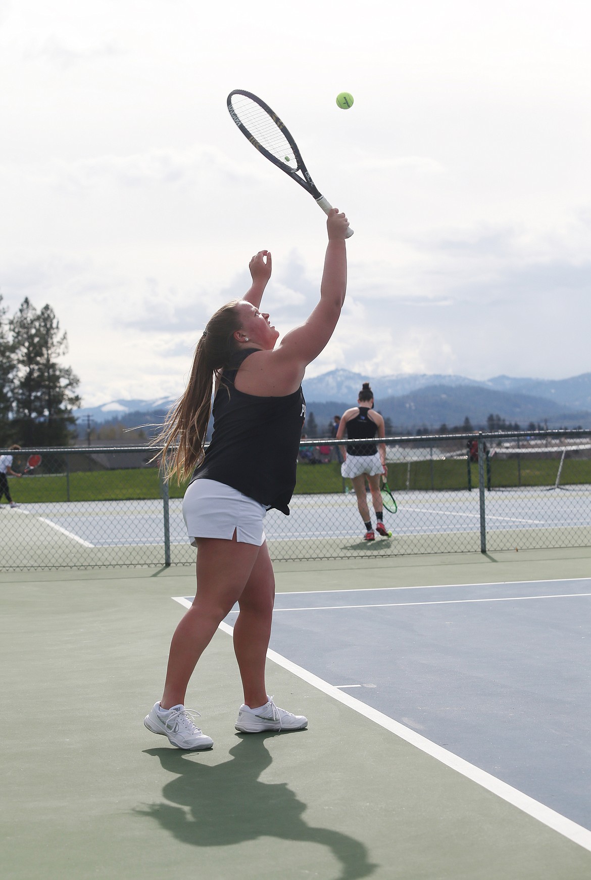 Courtney Finney of Post Falls High hits a serve in the No. 1 girls doubles match against Coeur d&#146;Alene.