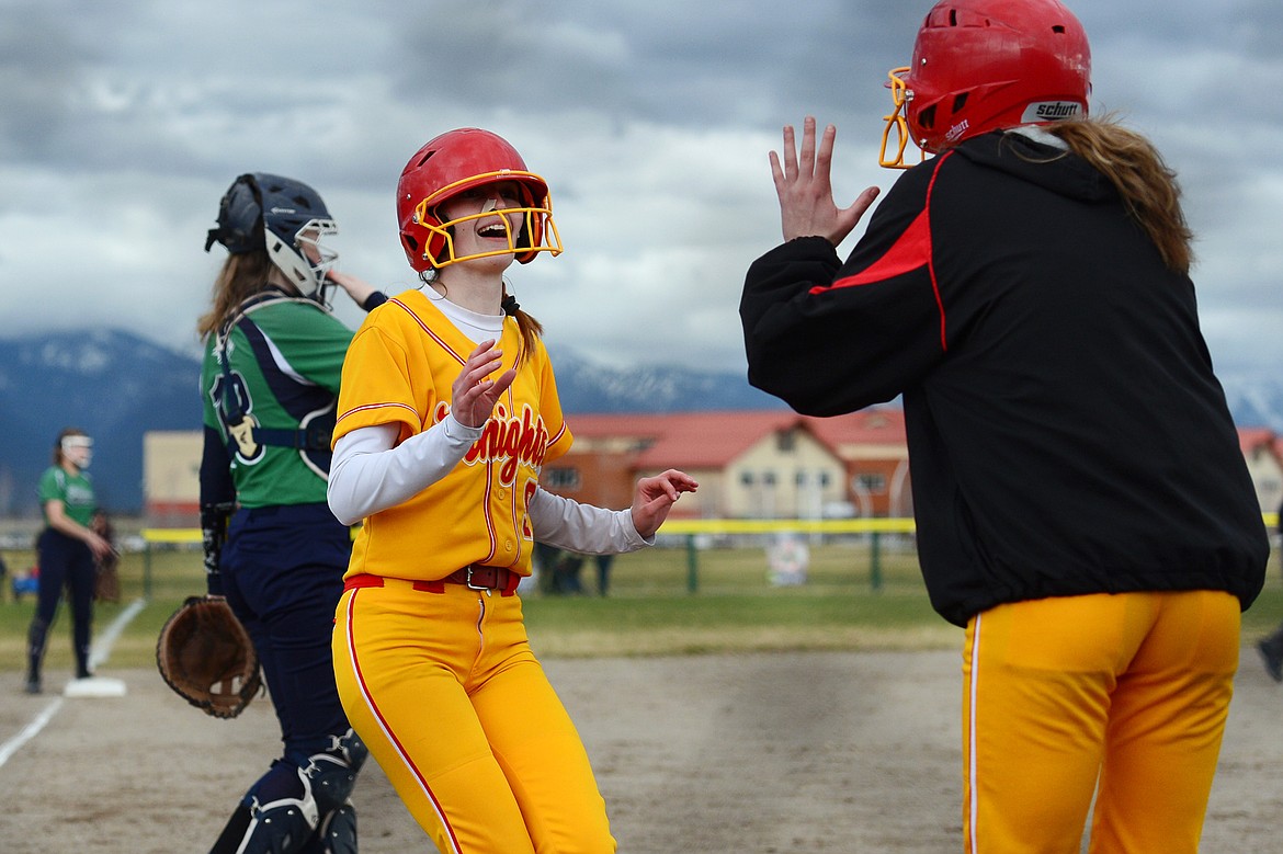 Missoula Hellgate's Megan McInnis (3) celebrates after scoring on a two-run single by Maddy Butler (7) in the third inning at Glacier High School on Friday. (Casey Kreider/Daily Inter Lake)
