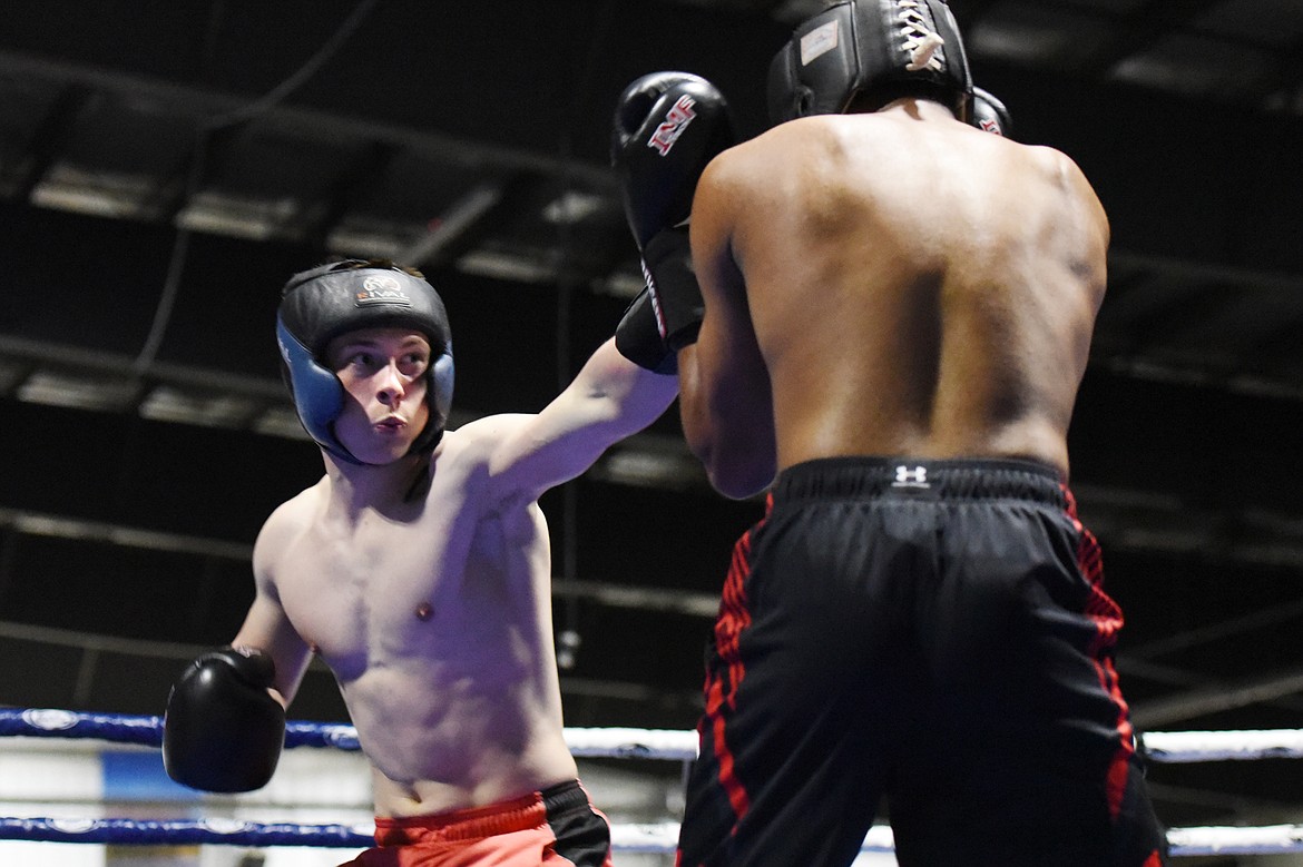 Glacier High School's Colton Todd, left, and Flathead High School's Austin Robinson trade punches during the Crosstown Boxing Smoker at the Flathead County Fairgrounds Trade Center on Thursday. (Casey Kreider/Daily Inter Lake)