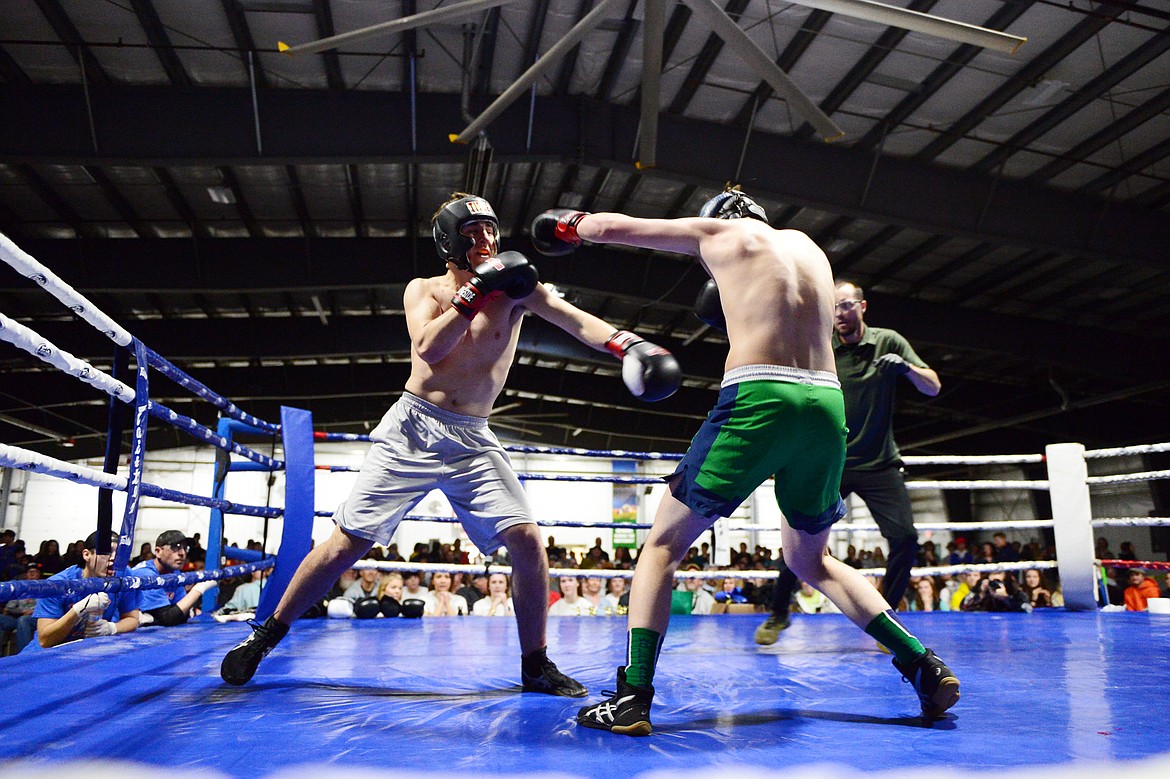 Flathead High School's Joel Turner, left, exchanges punches with Glacier High School's Tommy Croft during the Crosstown Boxing Smoker at the Flathead County Fairgrounds Trade Center on Thursday. (Casey Kreider/Daily Inter Lake)