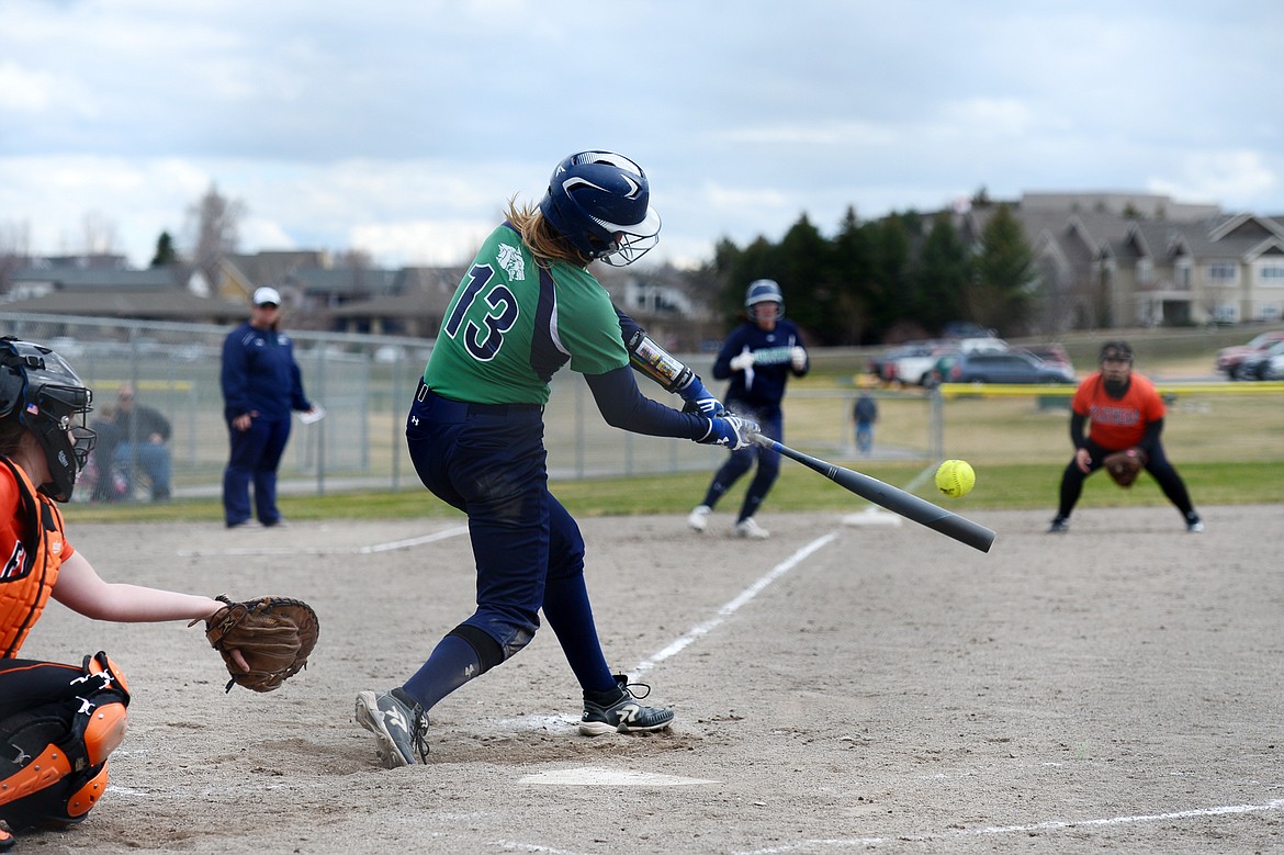 Glacier's Kynzie Mohl rips an RBI single in the third inning of the first game of a double header against Flathead at Kidsports Complex on Tuesday. (Casey Kreider/Daily Inter Lake)