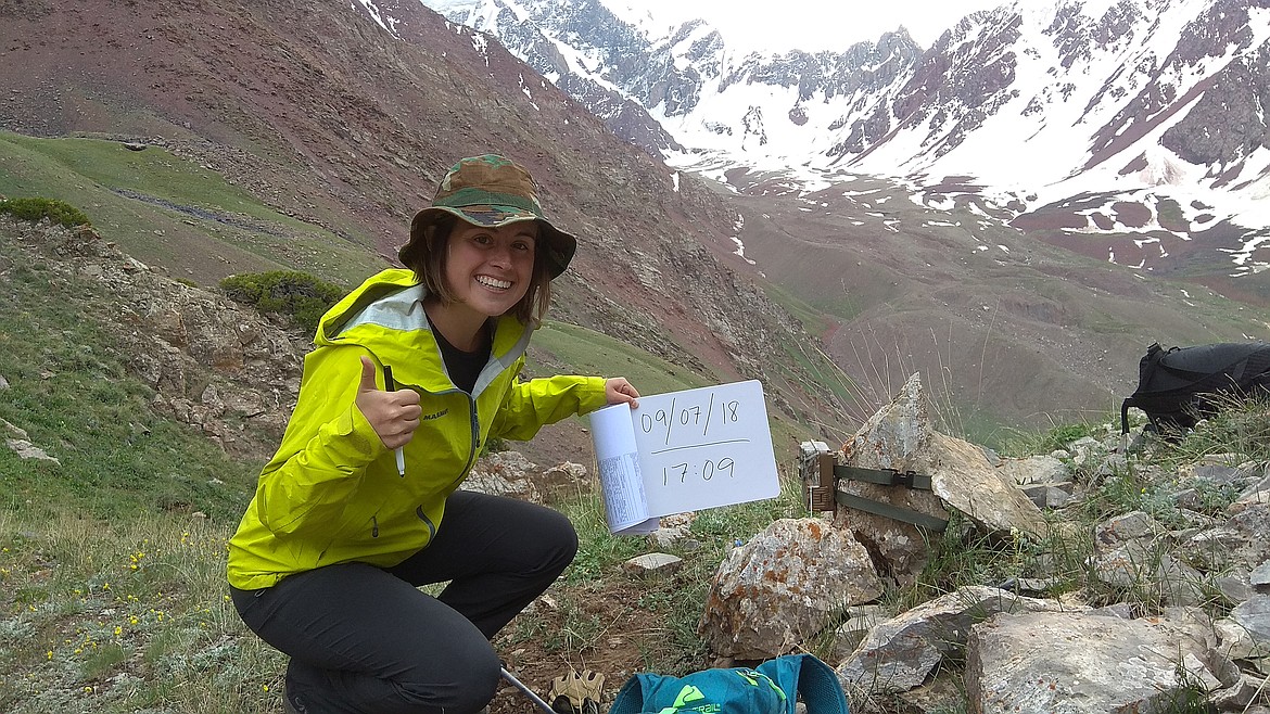 The 22-year-old sets a camera trap to record data on snow leopards. (Photo by Rahim Kulenbek)