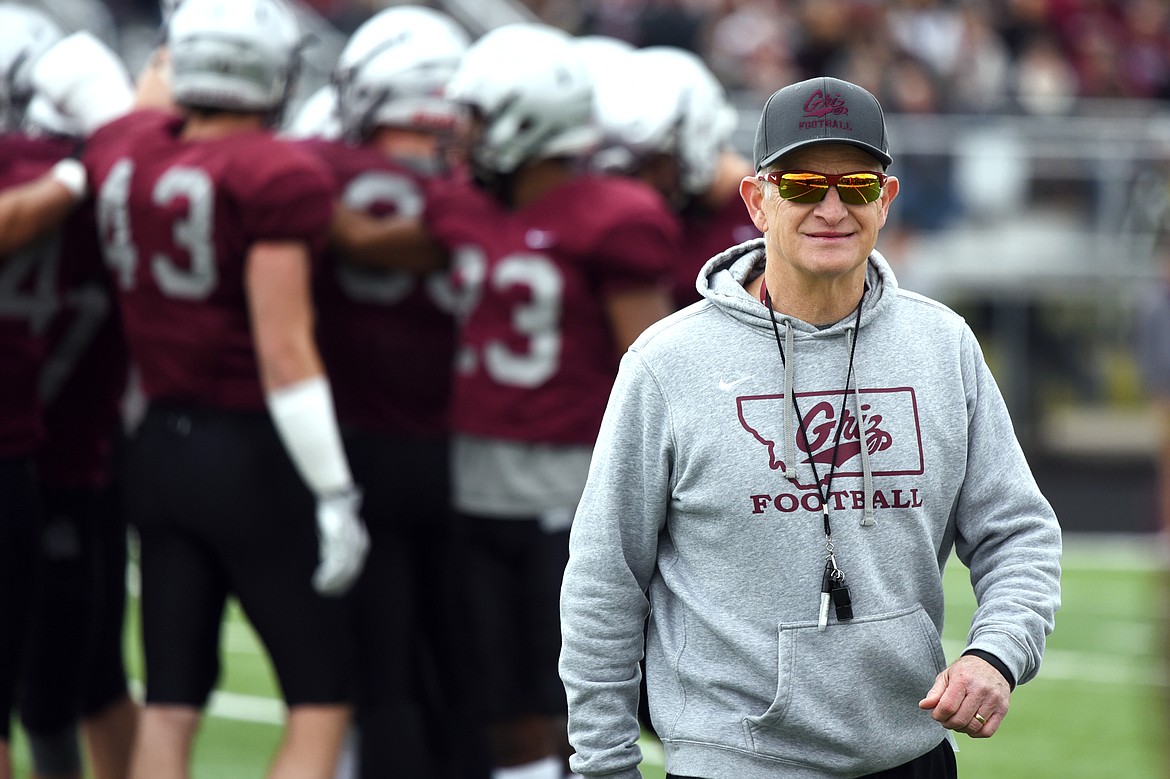Montana Grizzlies head coach Bobby Hauck smiles as he heads to the sideline after huddling with the Maroon team during the Spring Game at Legends Stadium in Kalispell on Saturday. (Casey Kreider/Daily Inter Lake)