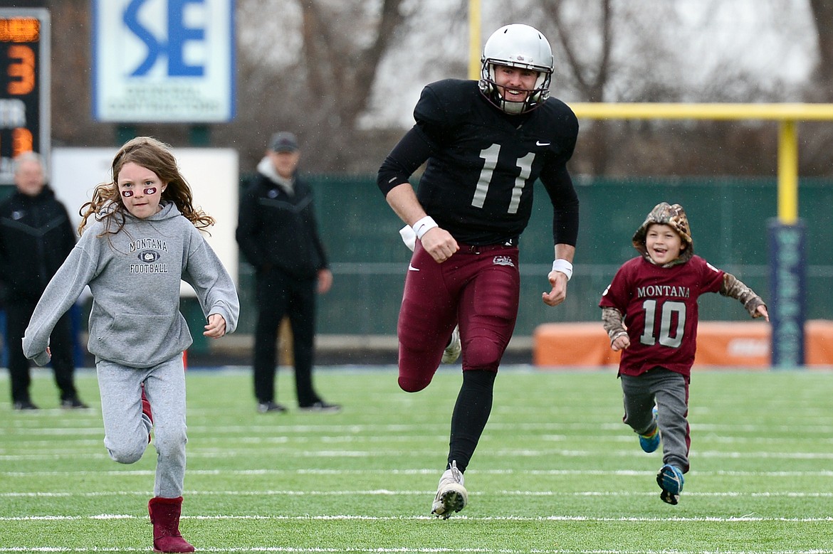 Montana Grizzlies starting quarterback Dalton Sneed (11) races a few youngsters during halftime of the Spring Game at Legends Stadium in Kalispell on Saturday. (Casey Kreider/Daily Inter Lake)